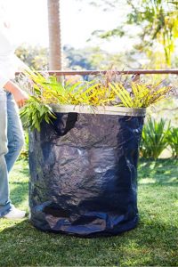 Free-standing Big Tuff garden bag filled with palm fronds for garden waste collection